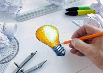 Designer drawing a light bulb, concept for brainstorming and inspiration