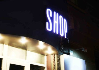 Neon sign on store at night